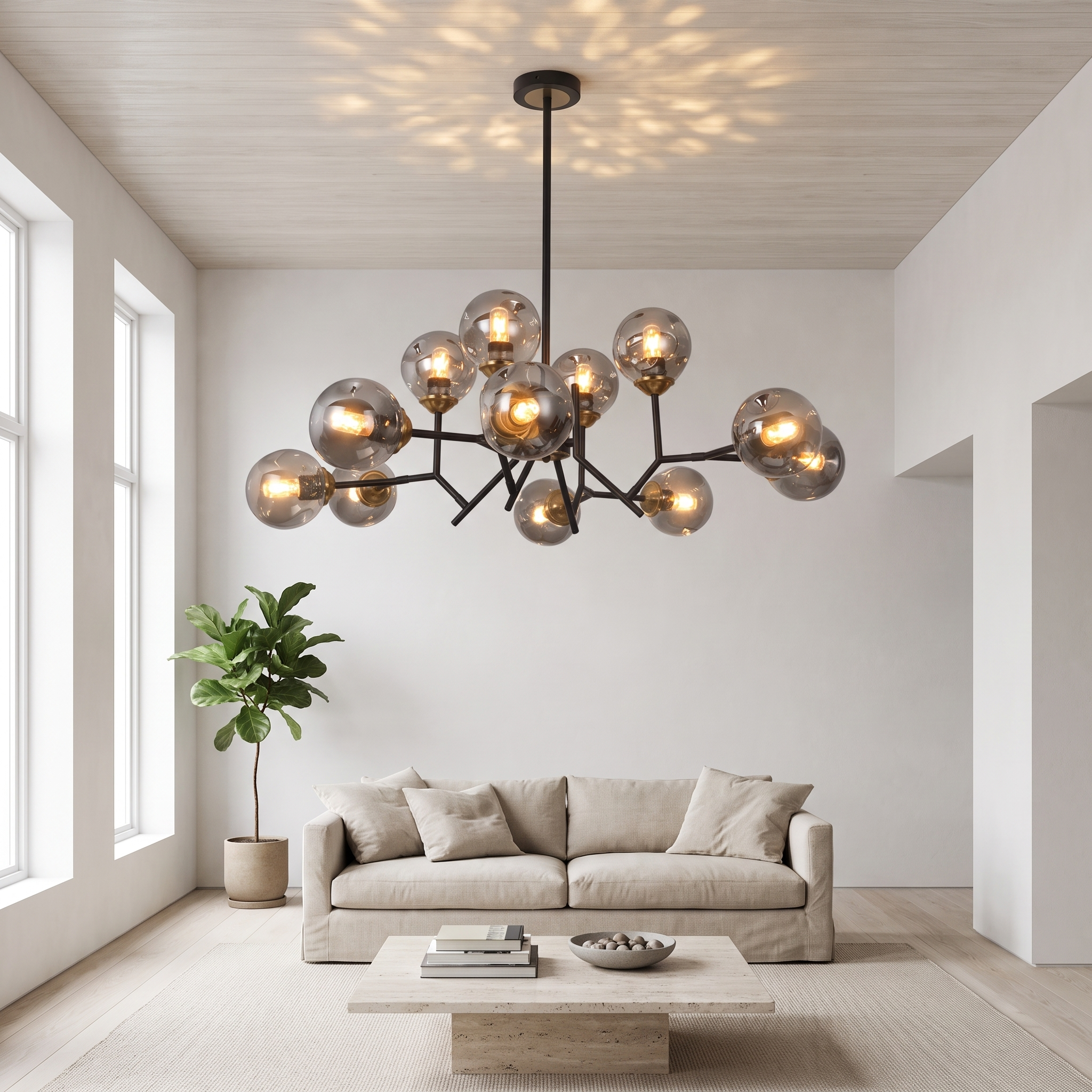 Deiphobos twelve-globe glass chandelier lit in a bright airy white living room with oatmeal linen sofa and travertine table