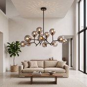 Deiphobos twelve-globe smoked glass chandelier in a bright double-height living room with linen sofa