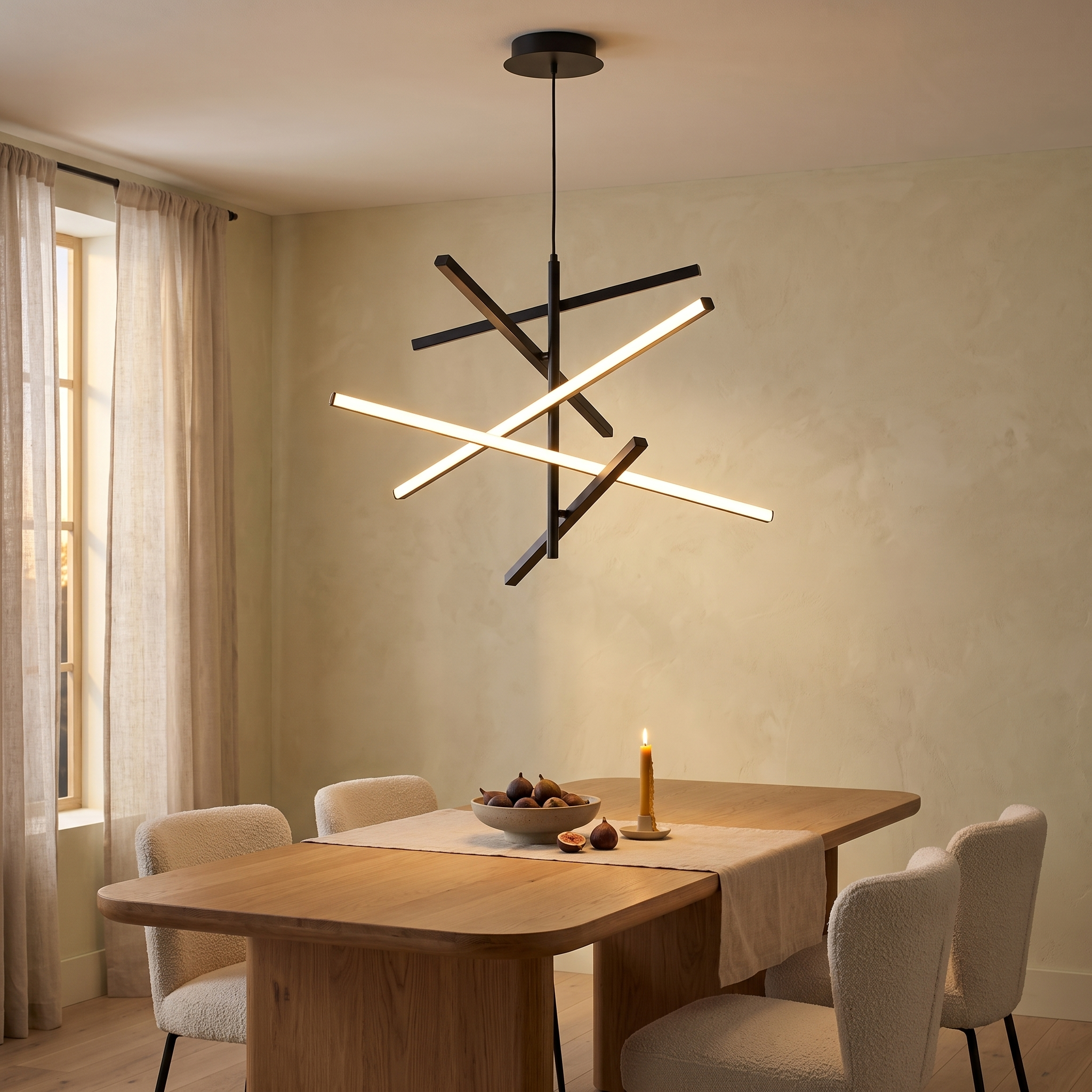 Nikandros black linear crossed-bar LED chandelier lit above an oak dining table in a warm lime-plaster dining room at dusk