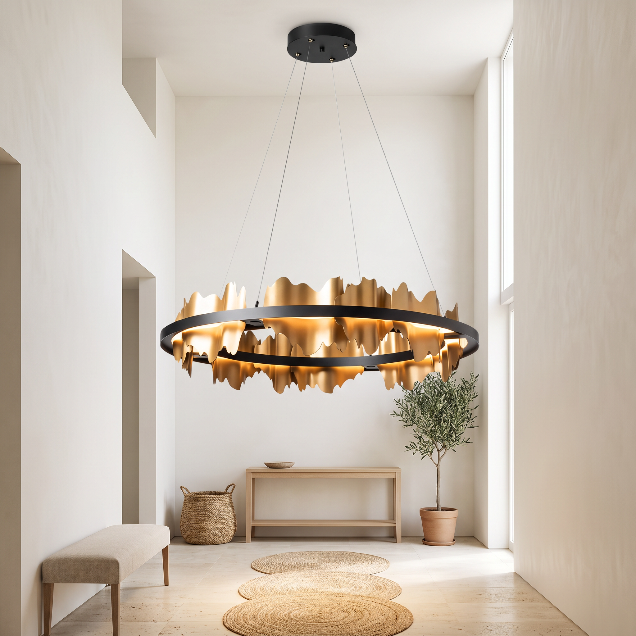 Danae black and gold leaf ring chandelier in a bright double-height plaster entrance hall with travertine floor