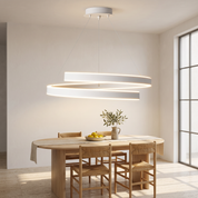 Andromache Ringed Nordic LED Chandelier lit above an oval oak table in a bright plaster dining room