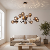 Deiphobos Twelve-Globe Glass Chandelier in a bright white plaster living room with linen sofa
