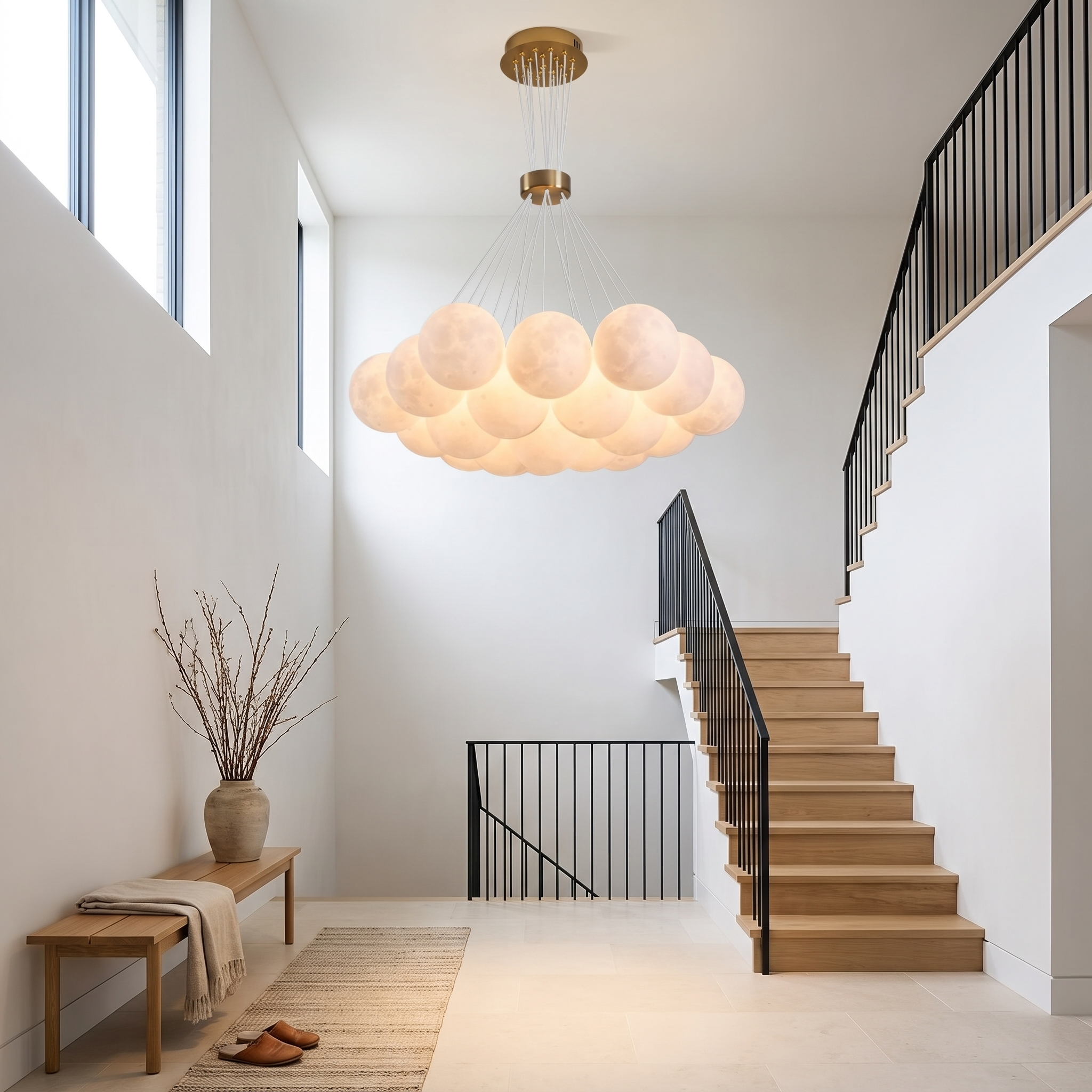 Chrysippos Cascading Globe Cluster Chandelier in a bright double-height stair hall with oak staircase