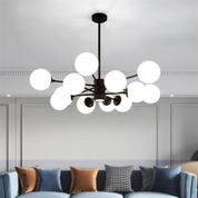 Nordic glass globe cluster chandelier suspended in an entryway, clear spheres catching the light