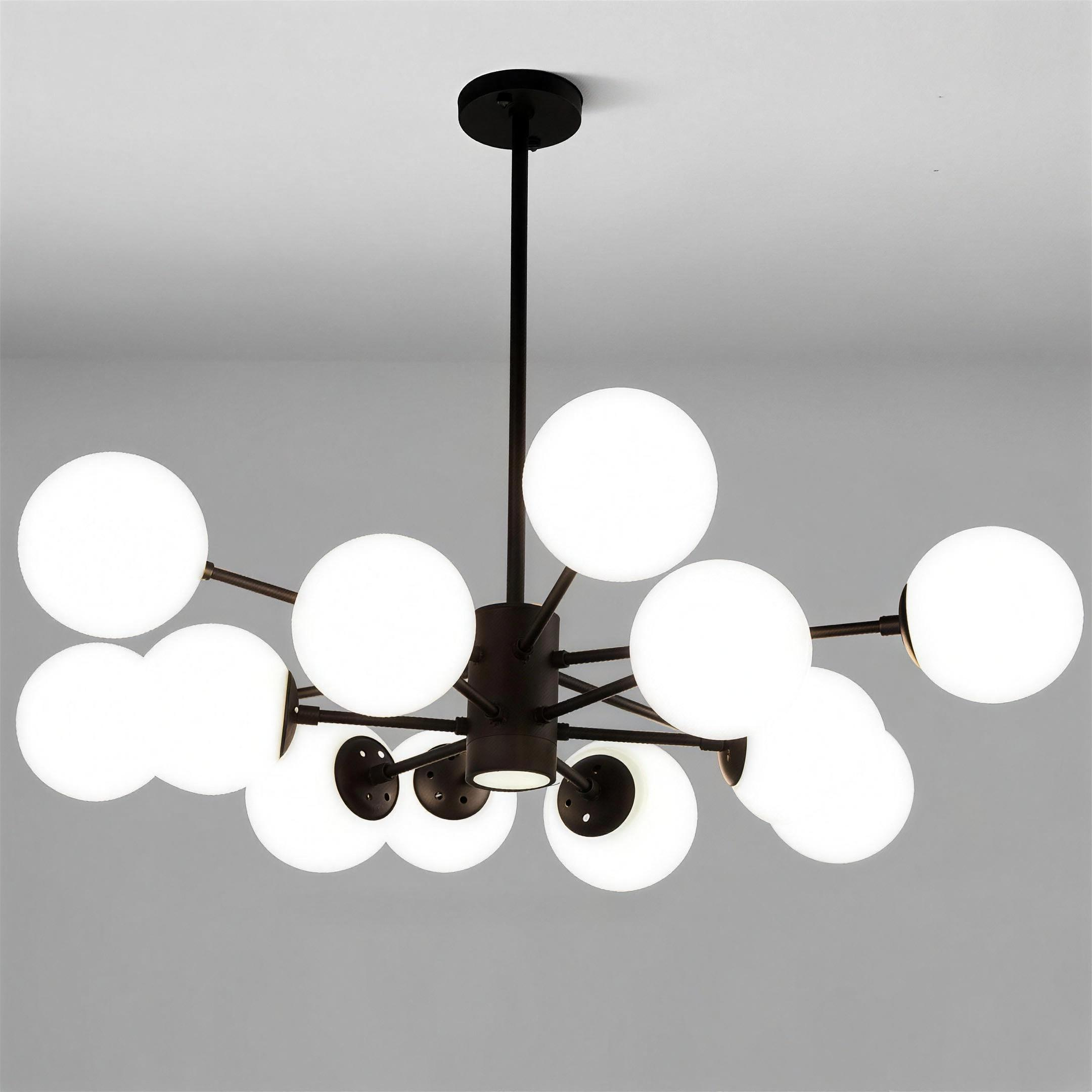 Glass globe cluster chandelier lit warmly over a modern interior seating area