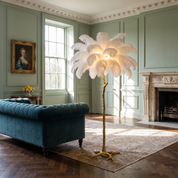 Phoinike ostrich feather floor lamp in white in a sage green panelled period drawing room in daylight