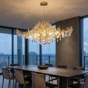 Aithra crystal chandelier over a stone dining table in a penthouse at dusk