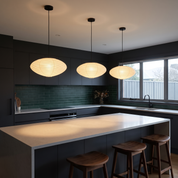 Three Leto washi paper pendant lights in a row over a charcoal kitchen island