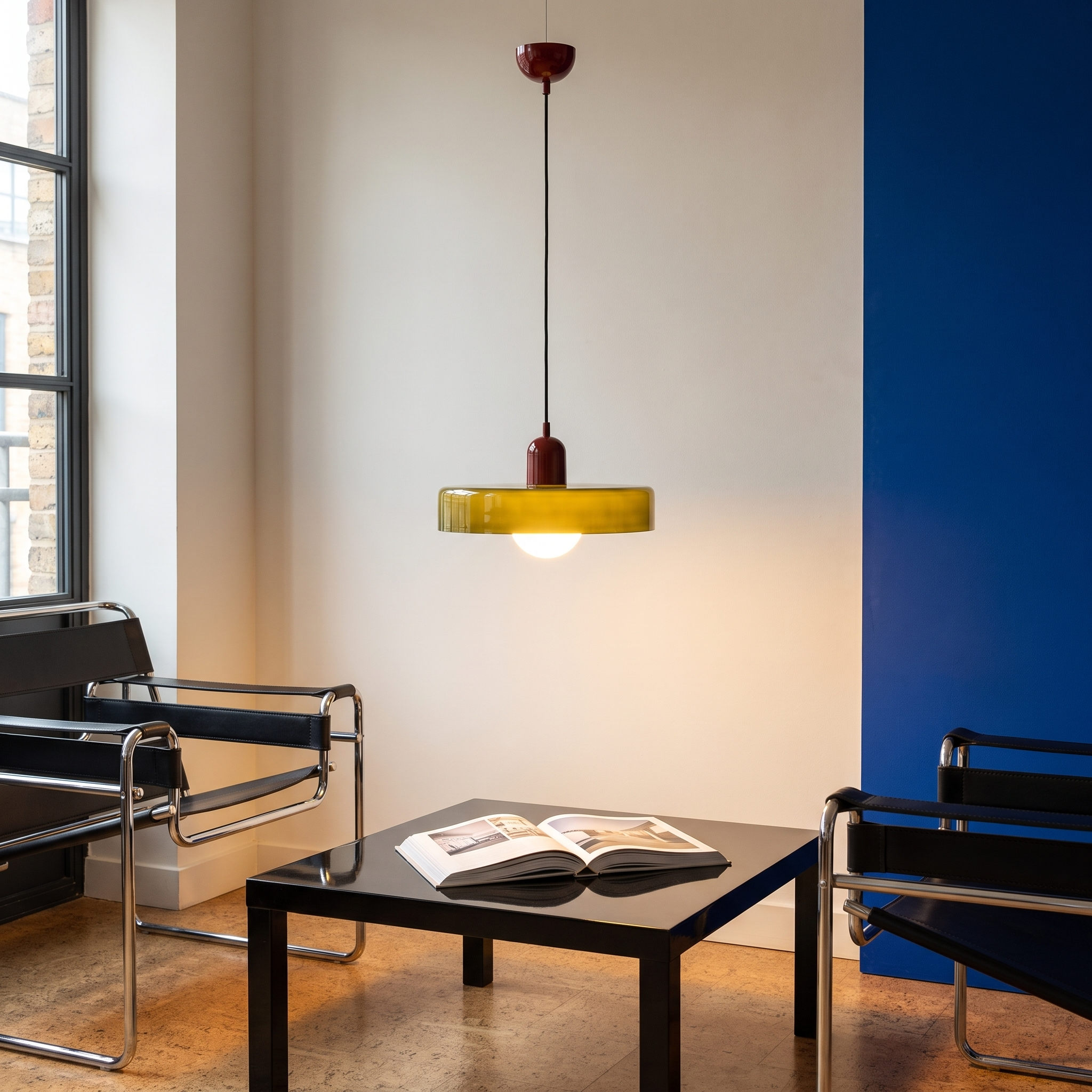 Iolaos colored glass pendant light in a Bauhaus library corner