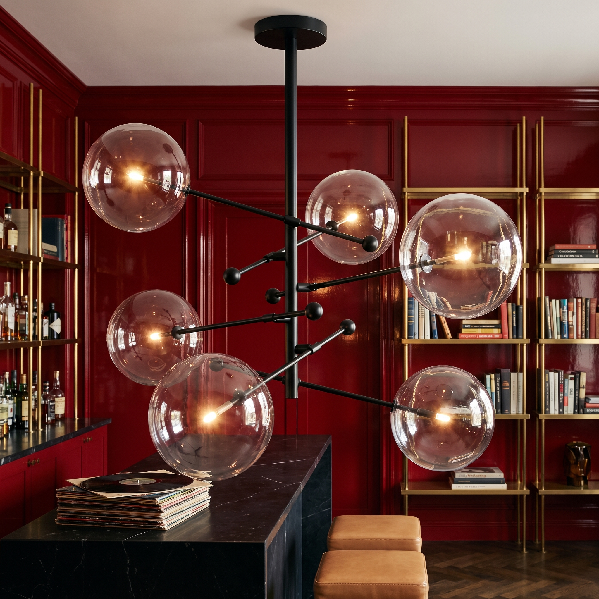 Hegesias black globe glass chandelier lit above a marble counter in a crimson lacquered library bar
