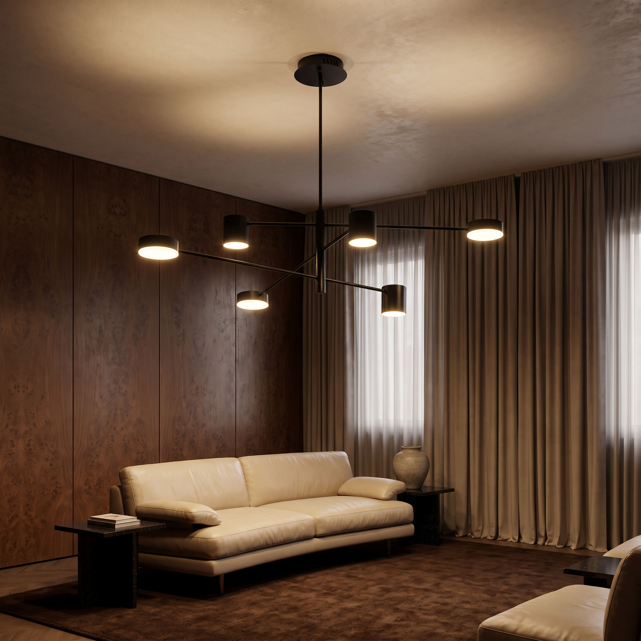 Doriskos black sputnik LED chandelier lit above a curved cream leather sofa in a burl walnut living room