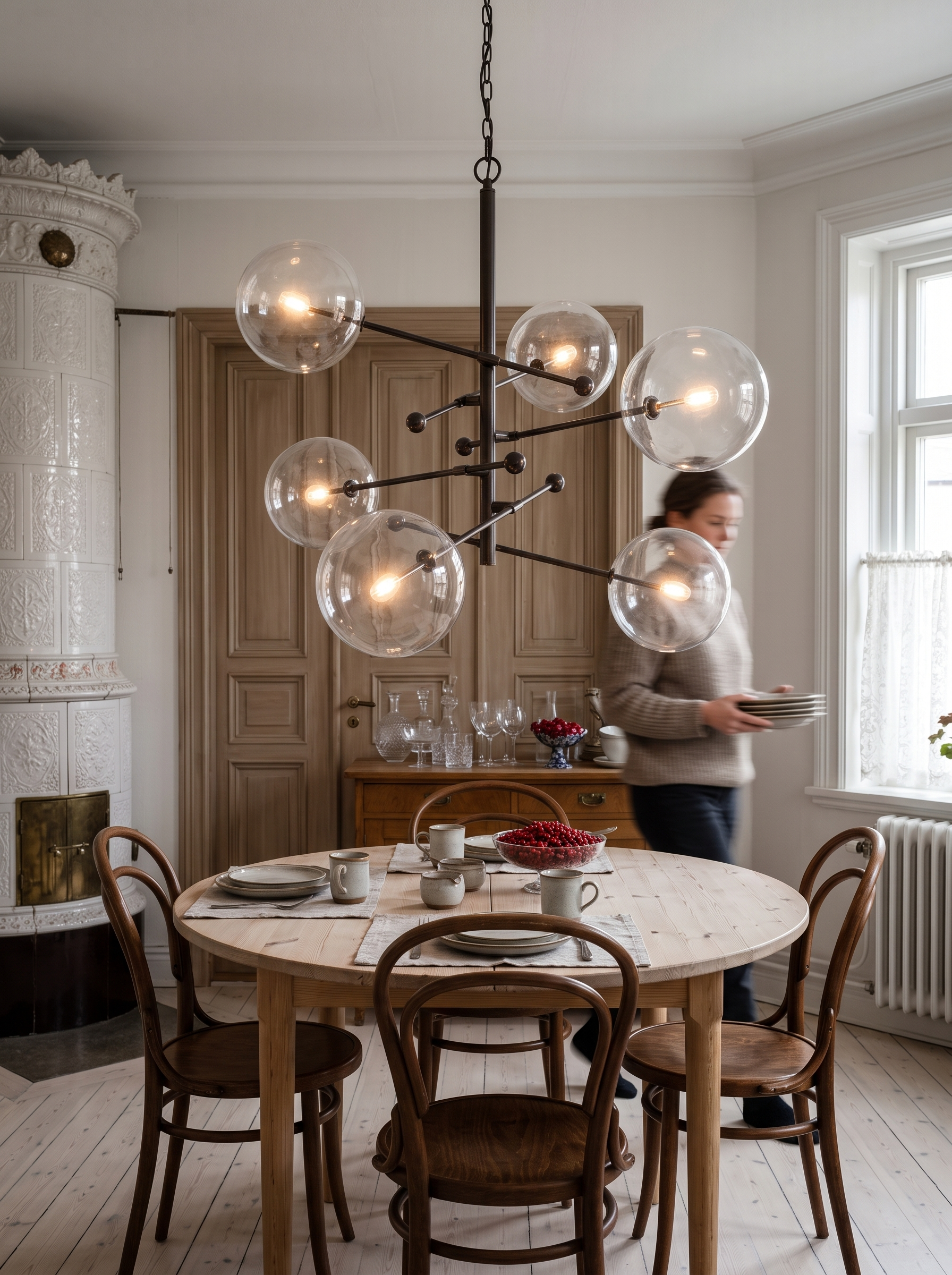 Hegesias Geometric Globe Glass Chandelier lit over a dining table