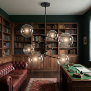 Hegesias geometric globe glass chandelier in black in a dark-academia study