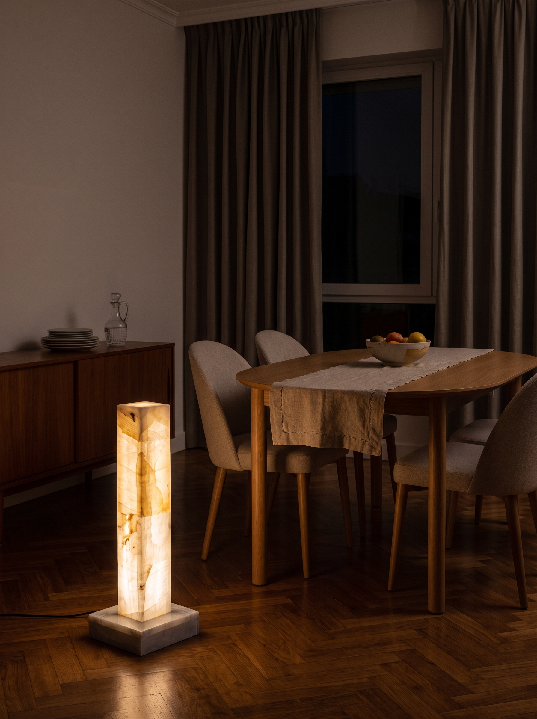 Chione alabaster floor lamp lighting a dining room at night