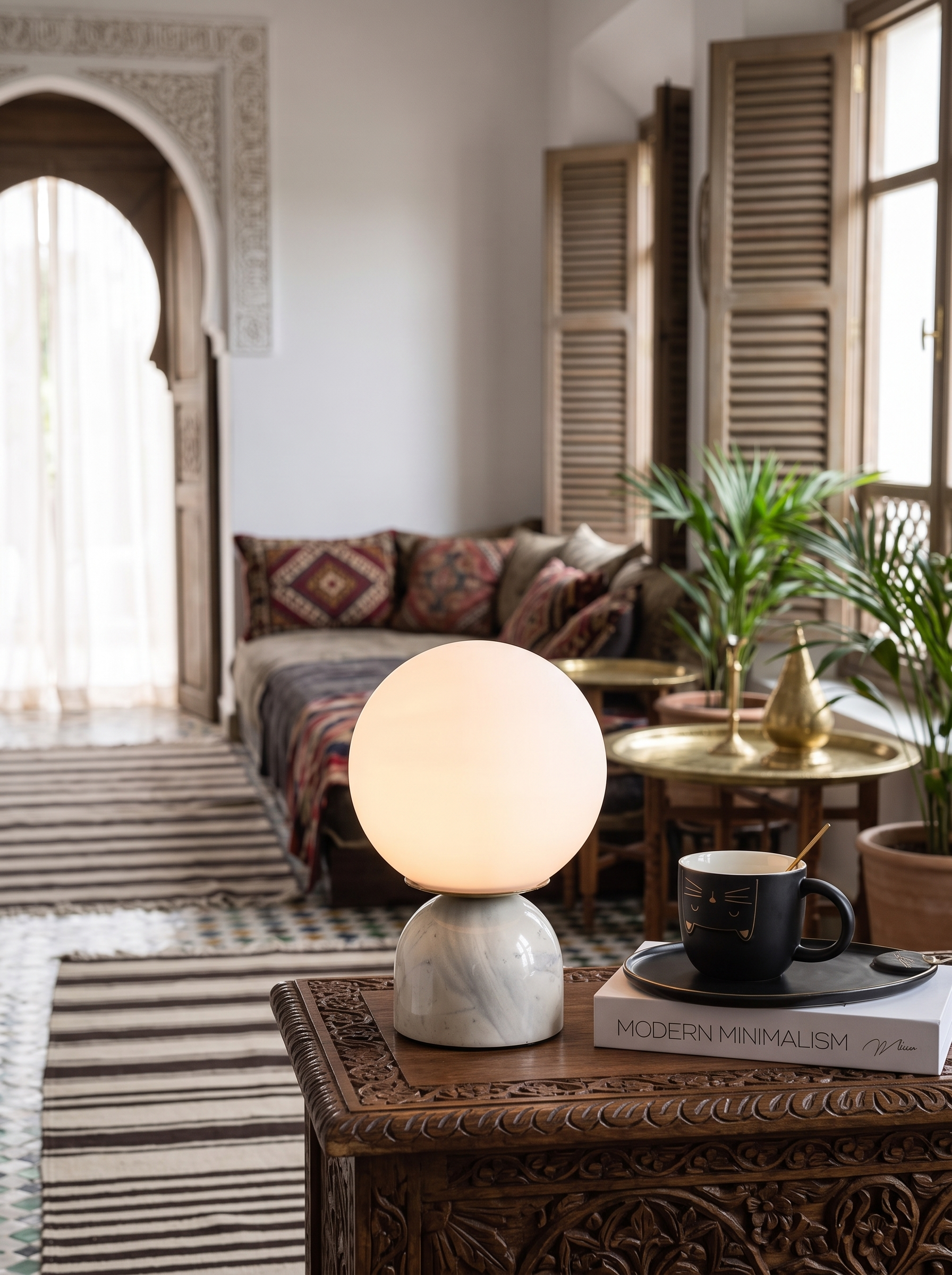 Semele marble and white glass globe table lamp close on a carved wood console