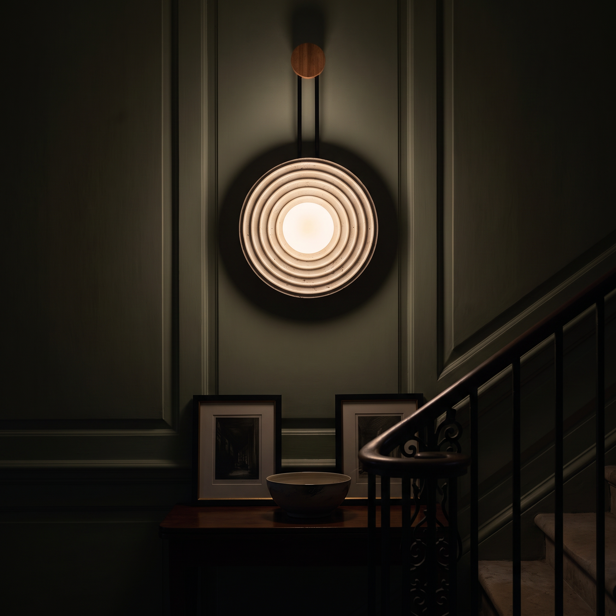 Halimede Tree Ring Travertine Wall Lamp lit at night in a Bath Georgian townhouse stairwell