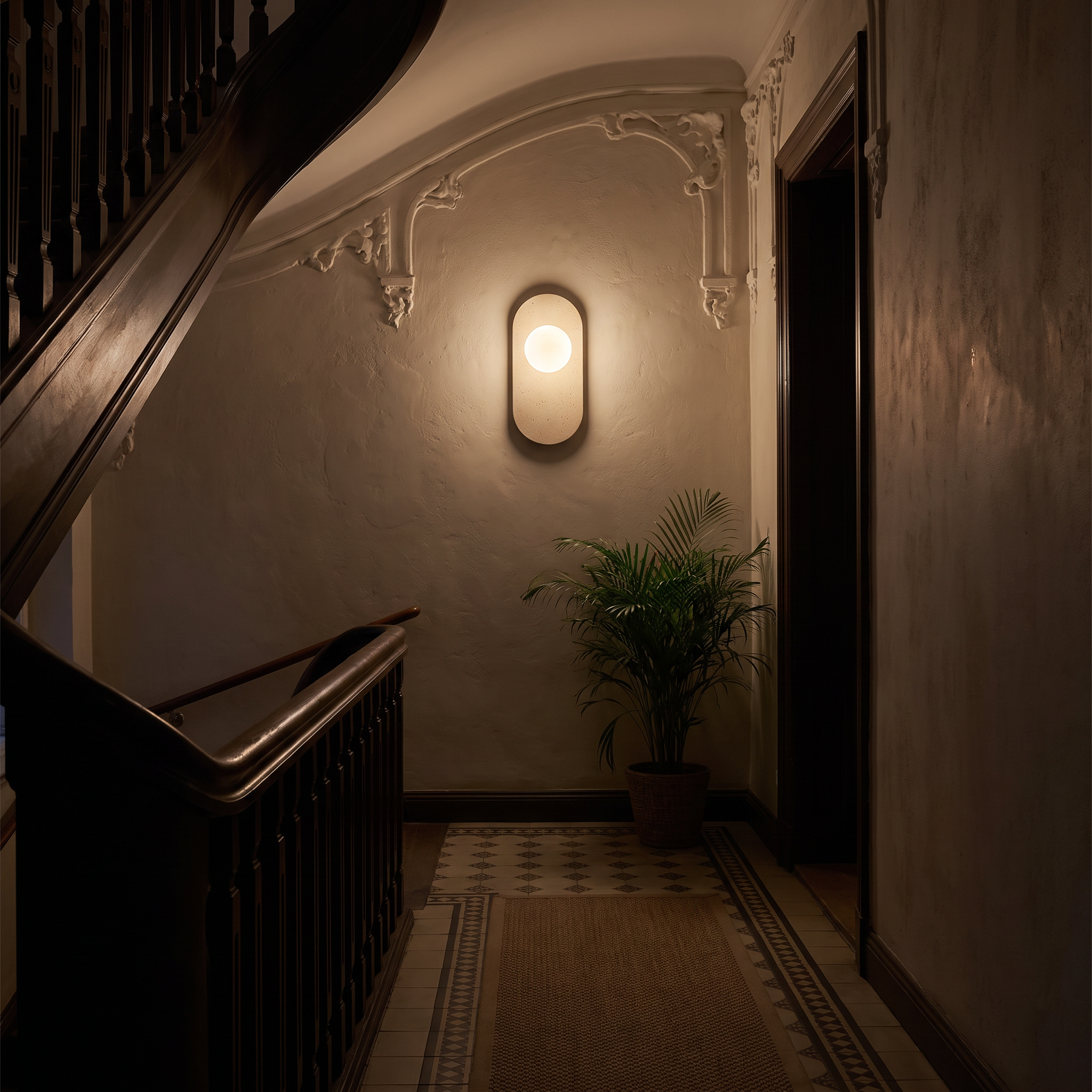 Harmonia Marble and Travertine Wall Sconce lit at night in a Riga Art Nouveau apartment stairwell
