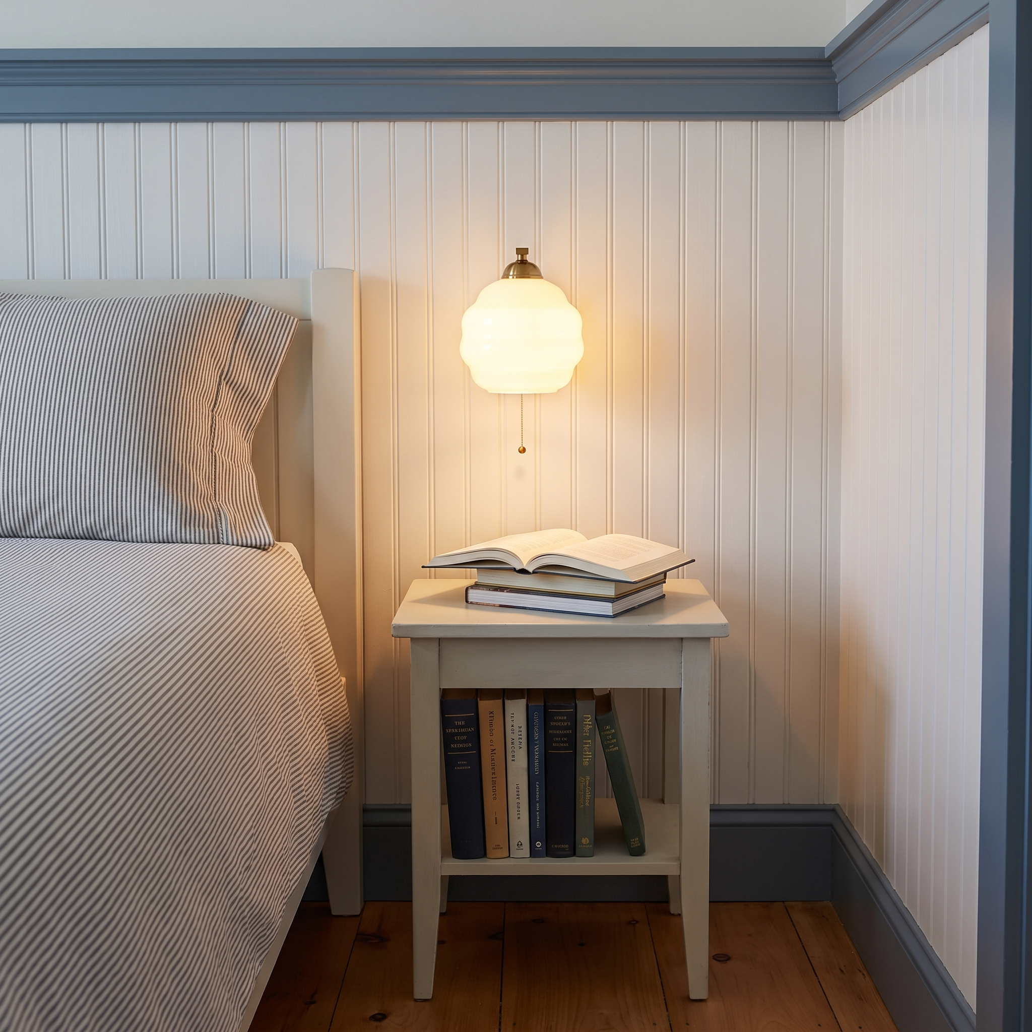 Eudore - Curved Glass Wall Sconce in Gold and Beige shown lit in an interior
