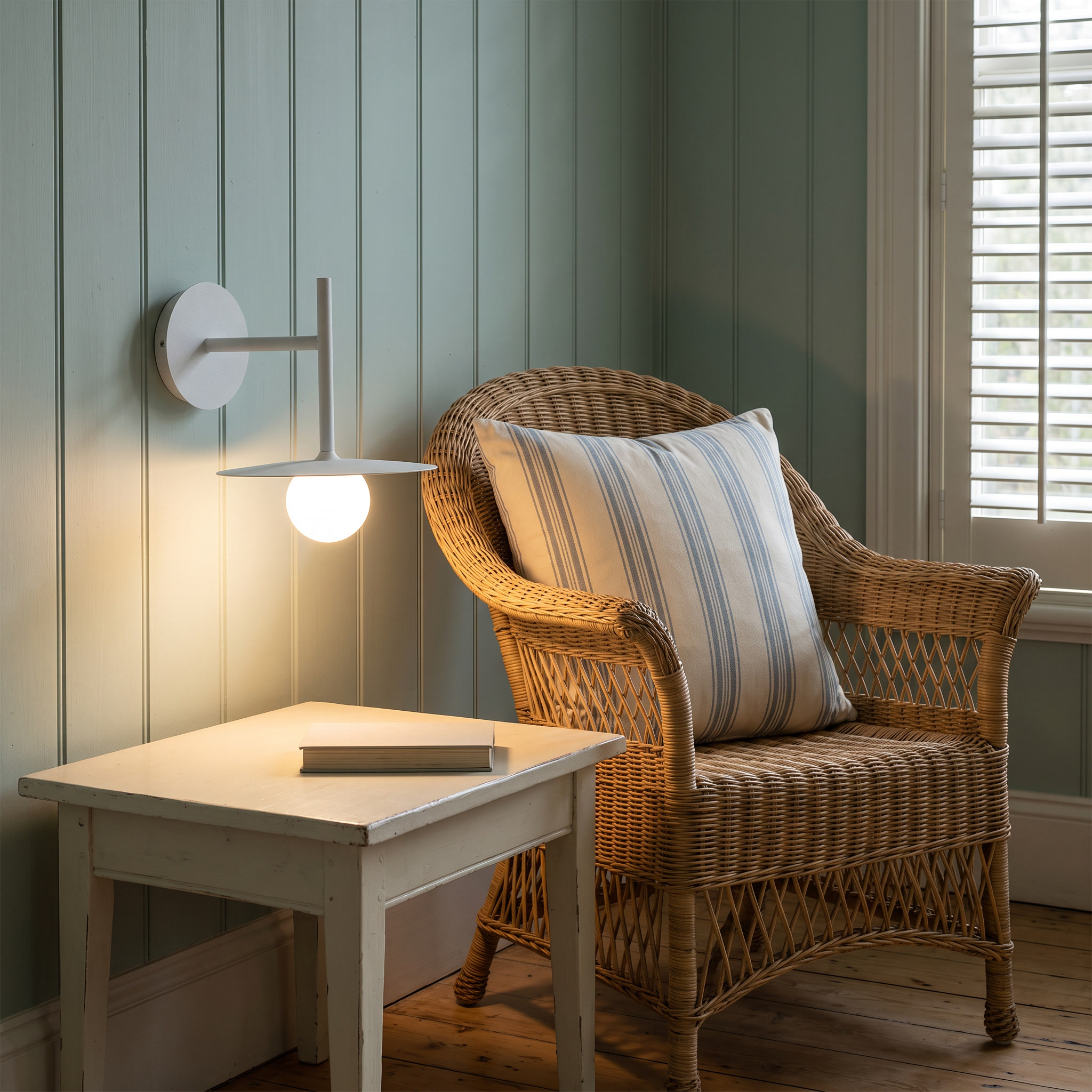 Hesione - Ironwork and Glass Wall Lamp shown lit in a resort villa sitting room