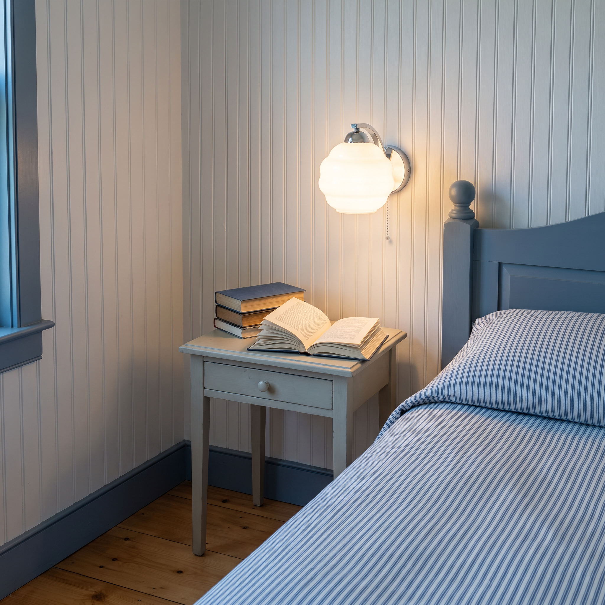 Eudore - Curved Glass Wall Sconce in Chrome and White shown lit in an interior