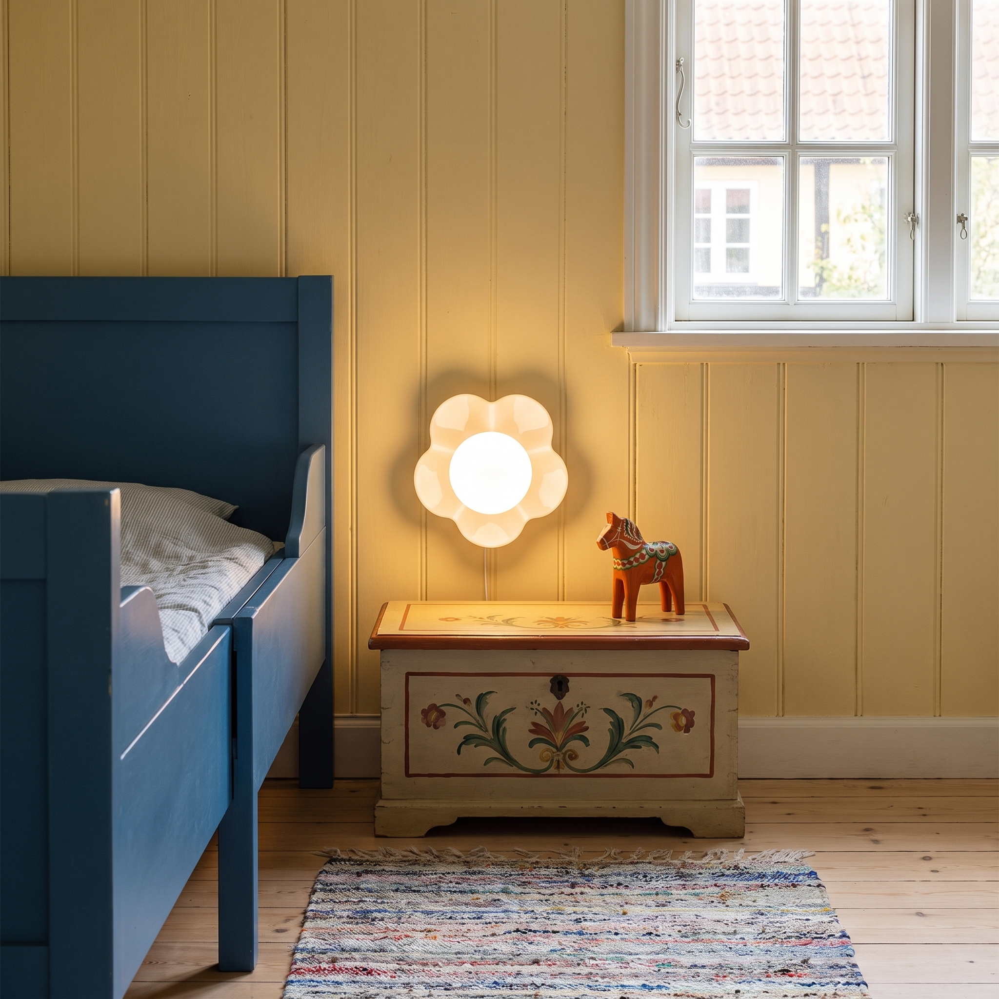 Pheme - Resin and Glass Wall Light shown lit beside a bed in an interior