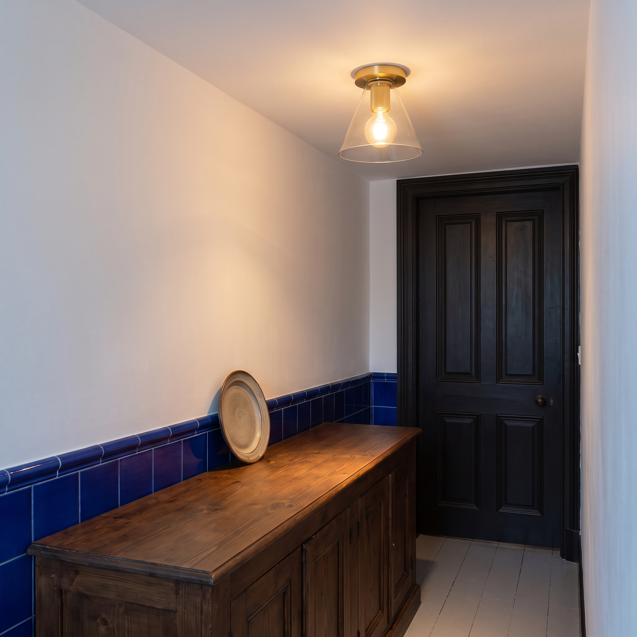 Lysidike brass and clear glass flush light in a hallway