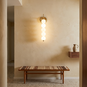 Radford - Brass and White Glass Wall Lamp in a styled interior