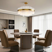 Hermione glass rod chandelier over a circular table in a neutral interior