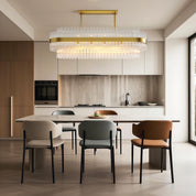 Hermione glass rod chandelier in an elegant dining area beside a sleek kitchen