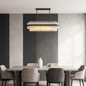Hermione glass rod chandelier over a rectangular table in a minimalist dining room