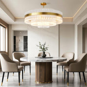 Hermione brass and glass rod chandelier above a round dining table